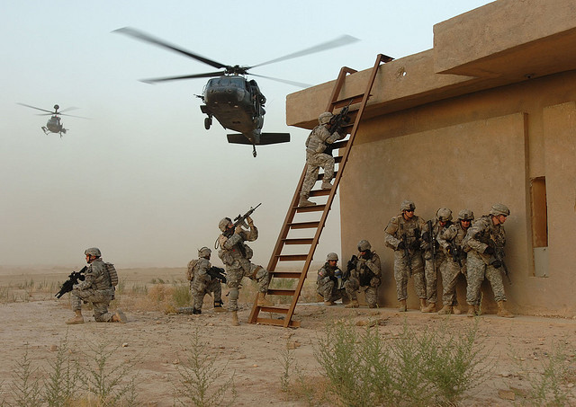 U.S. troops enter a building in Iraq. U.S. troops were sent home in 2011 but may need to return to fight ISIS. 