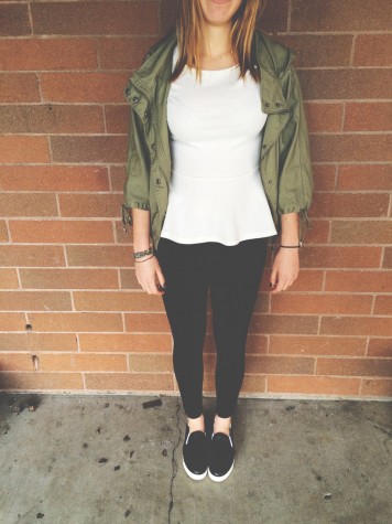 Junior Natalie Herder is wearing a peplum top, army green jacket, black pants, and slip on vans. This is a great outfit for a cool spring day.