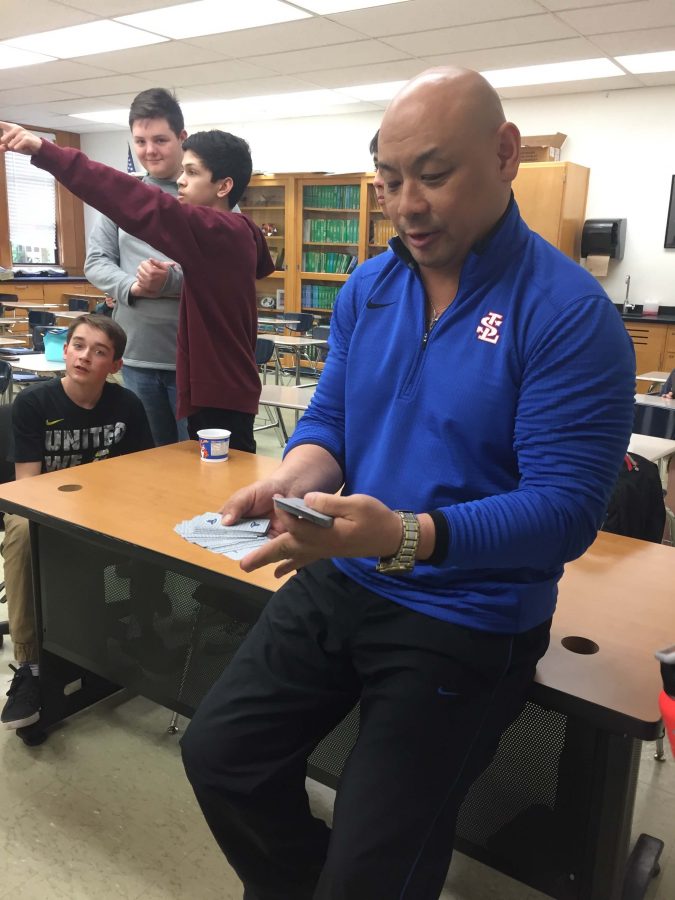 Mr. Oey demonstrating to his students one of his many card tricks