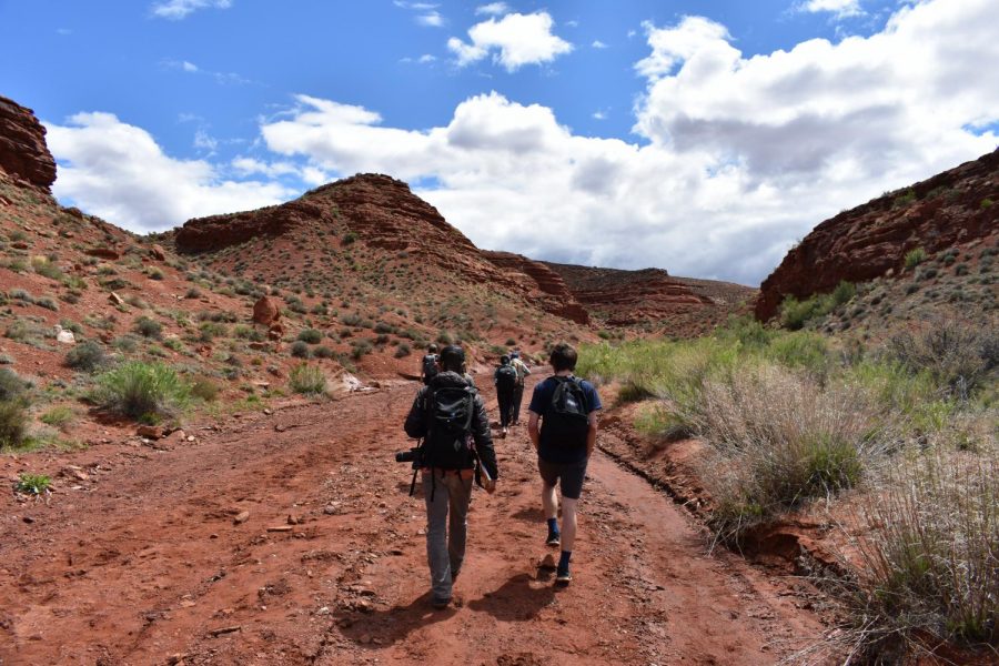 Senior Jake Bunker and camp guide Dipper hike through a dried stream.