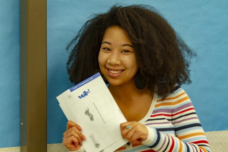 Senior Amira Tripp Folsom shows the form to register to vote.