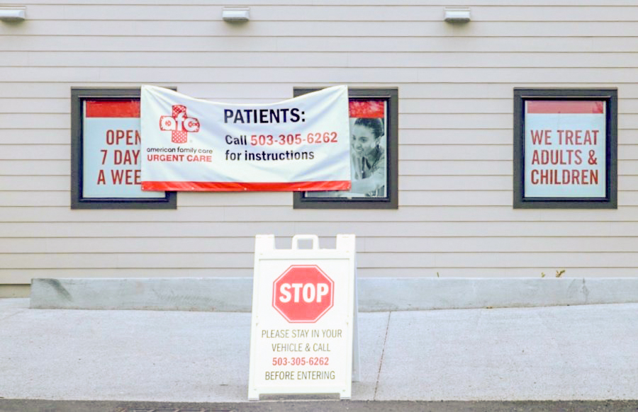 An+urgent+care+center+in+Oregon+City+displays+signs+warning+visitors+to+take+necessary+social+distancing+precautions.