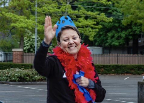 Ms. Powell waves to students at a recent