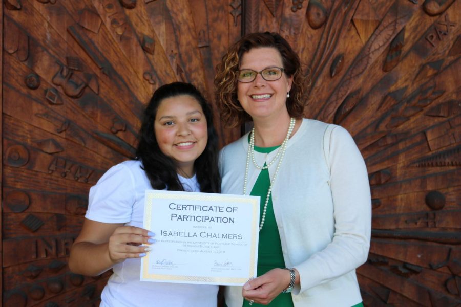 Caption: Chalmers received a certificate from Casey Shillam, the Dean and Professor of University of Portland’s School of Nursing, after completing the 2019 summer nursing program. 