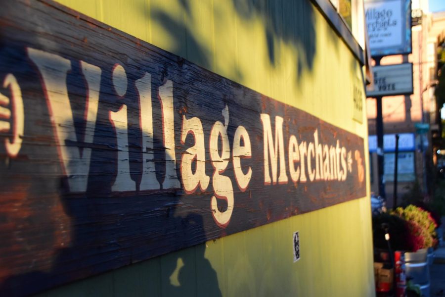 Village Merchants, located on Division Street, is characterized by its light green exterior.