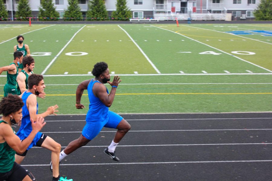 Sophomore Zachariah Frazier sprints the 100-meter dash and finishes with a time of 12.02 seconds, winning his heat and placing first in a meet against Parkrose High School.