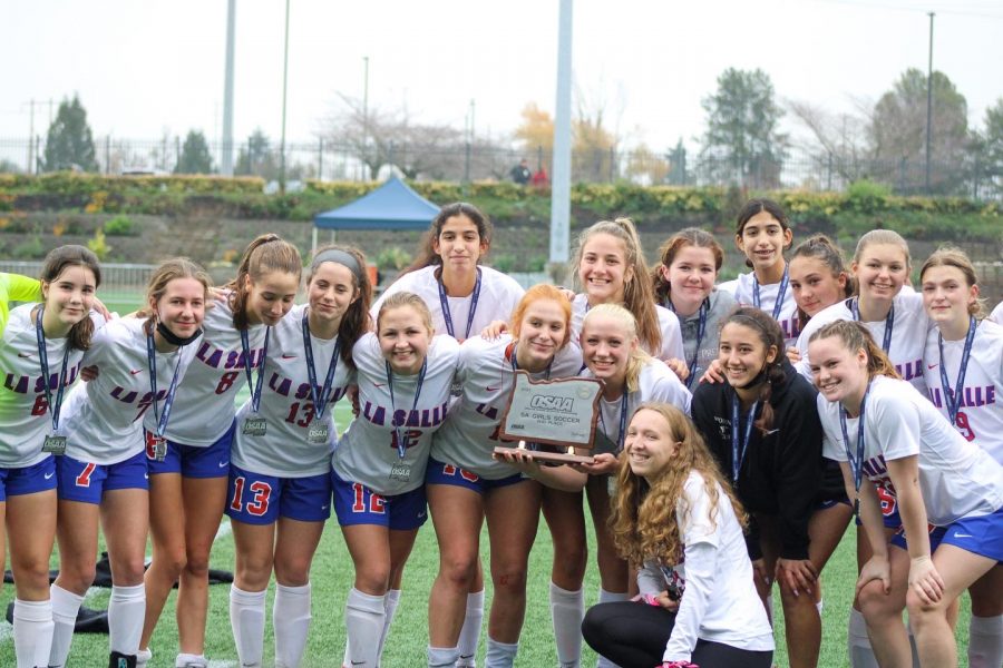 The La Salle varsity girls soccer team posed with their silver state championship trophy.