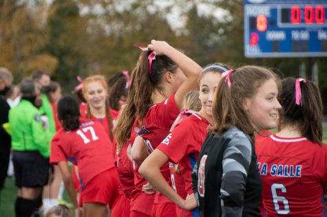 The girls stood at the sidelines before the game as they waited for the game at 3:30 p.m.