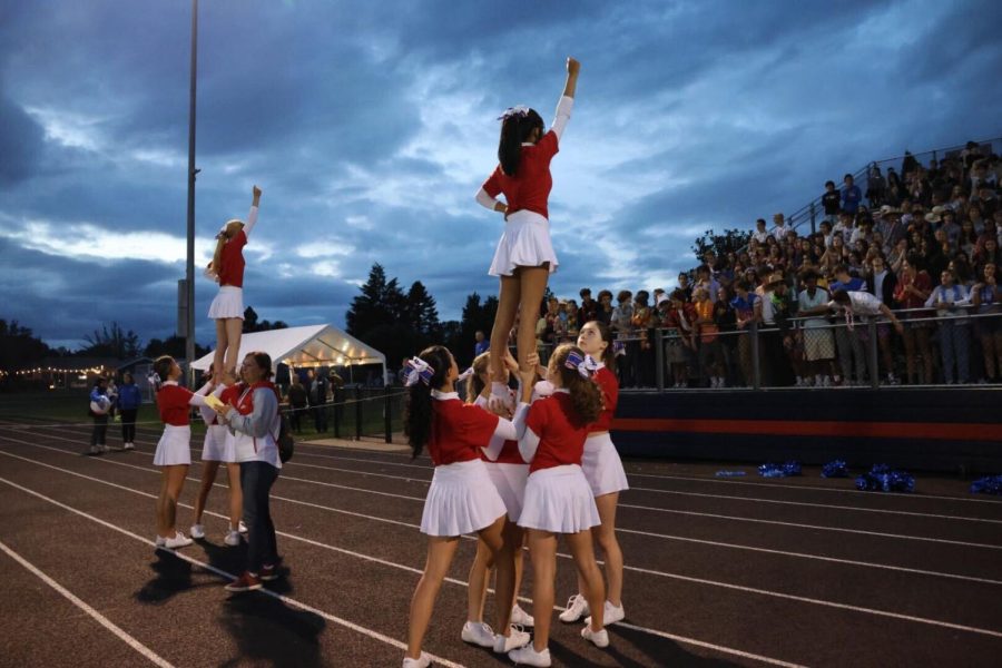 The Falcon cheerleaders perform one of their more difficult stunts during the football game this season and help get the crowd energized. 