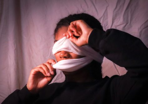 In this photo, I chose to cover my eyes and mouth with a white cloth to represent the isolating experiences I’ve had at predominantly white schools. The cloth symbolizes how I have been held back and mistreated by some of my white peers and teachers, and my hands peeling back the cloth is me bravely stepping forward and telling my story for the first time.