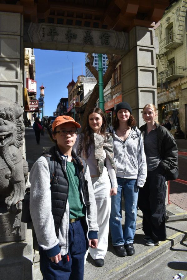 Before entering Chinatown, the group poses before the Dragon Gate.
