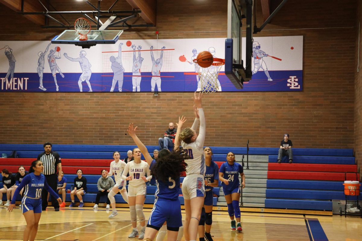  Sophomore and co-captain Ava Bergeson shoots around the Hillsboro player guarding her.