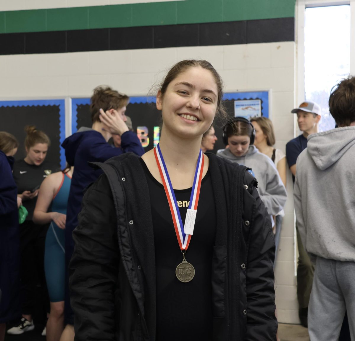 Junior Kayla Chapman stands tall with a medal labeled “Northwest Oregon Conference Champion” after breaking the record for La Salle, not once, but twice.