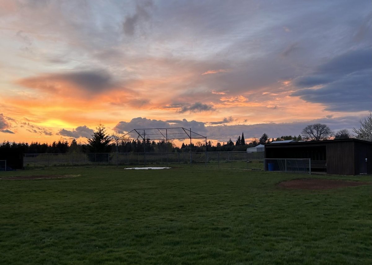 The sun sets over the baseball fields.