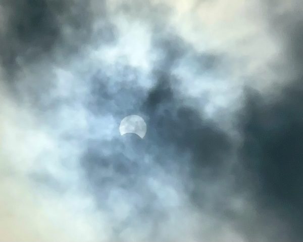 The partial solar eclipse in the Portland area was hidden by the clouds, but made a slight appearance around 11:27 a.m. as the clouds shifted away.