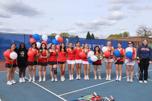 Friends and family gathered to celebrate the 14 seniors on the girls tennis team with balloons, cookies, and flowers. 