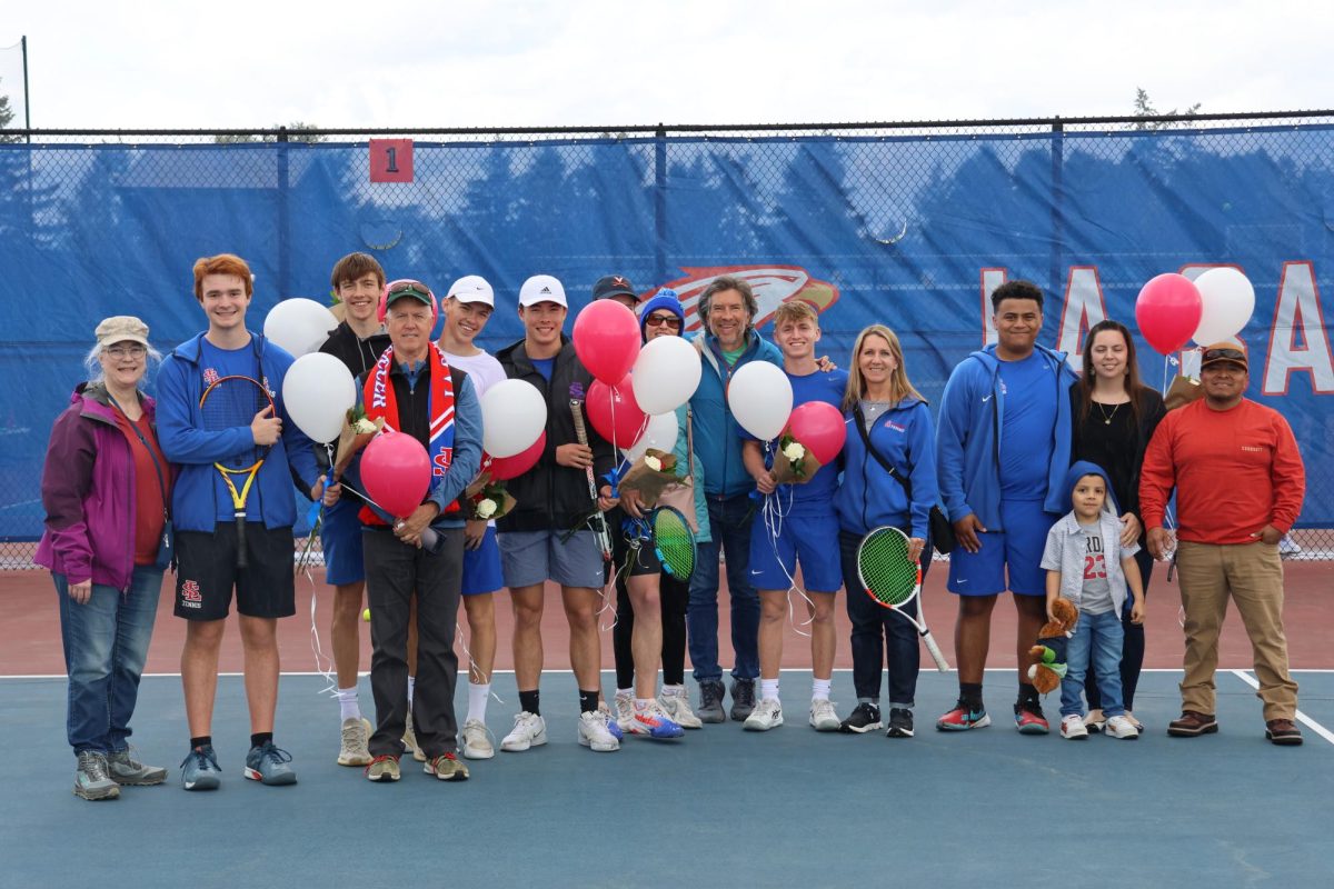 Once the rain subsided, the boys tennis team held their senior presentations before their matches, recognizing seven graduating varsity players with flowers and balloons.
