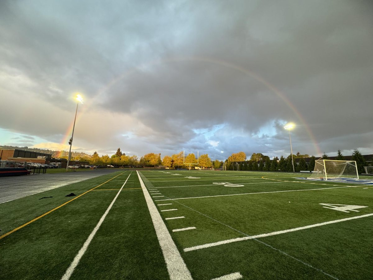 A rainbow stretches across the football field.
