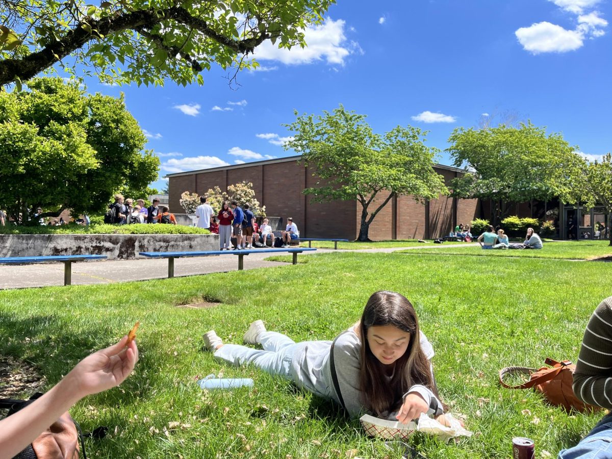 Students eat outside in the courtyard to enjoy the warm sun on May 16.