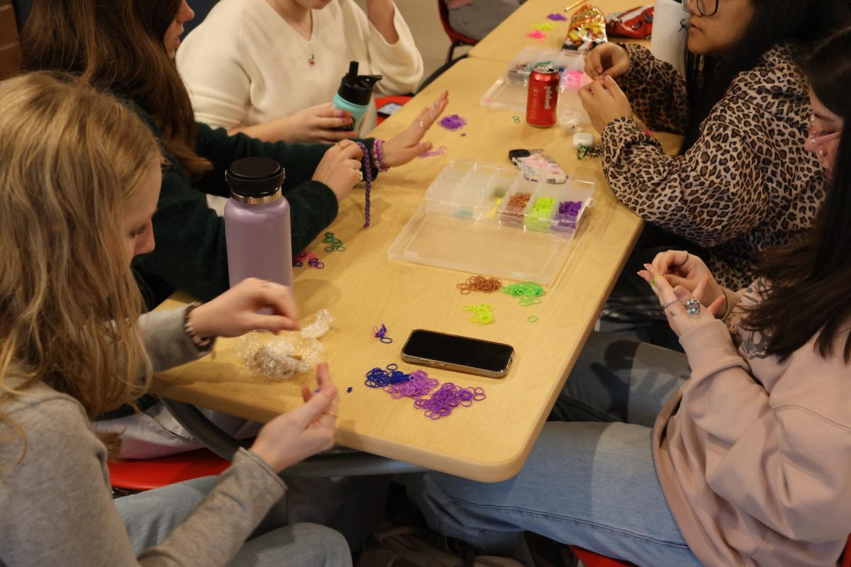 Students unwind by crafting friendship bracelets in the main hallway.
