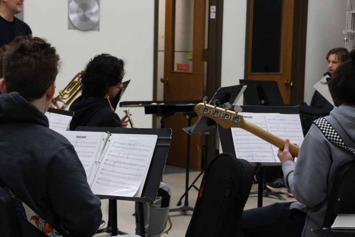 Band students practice song such as “Footloose” and “Material Girl” early before late start on Friday, March 14.