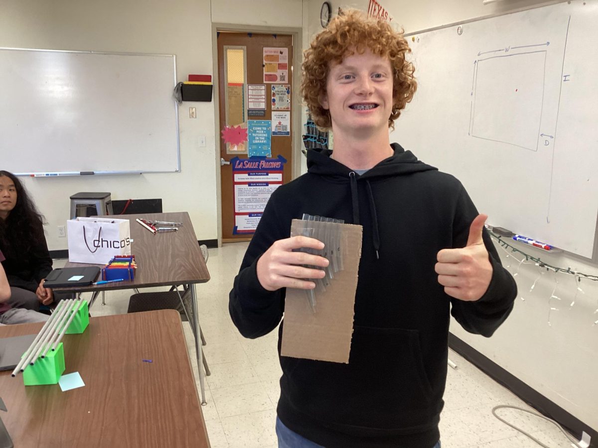  Sophomore Harris Jones constructed a pan flute for his physics project out of straws and cardboard.