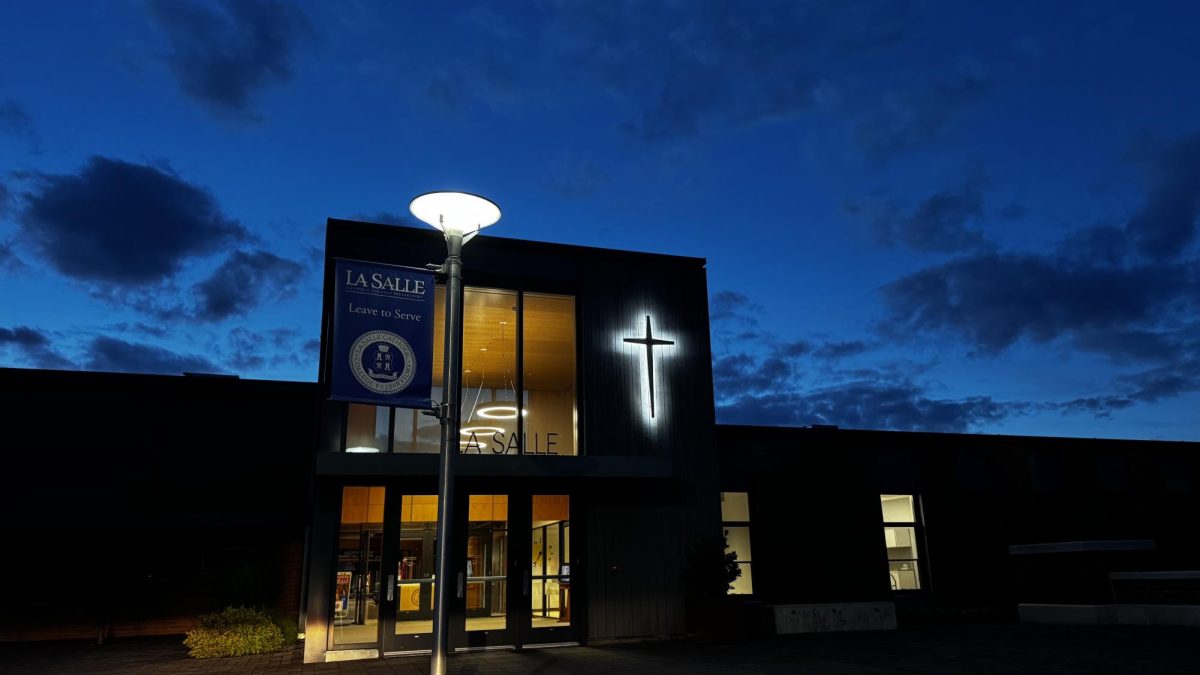 La Salle's main entrance illuminated under the night sky.