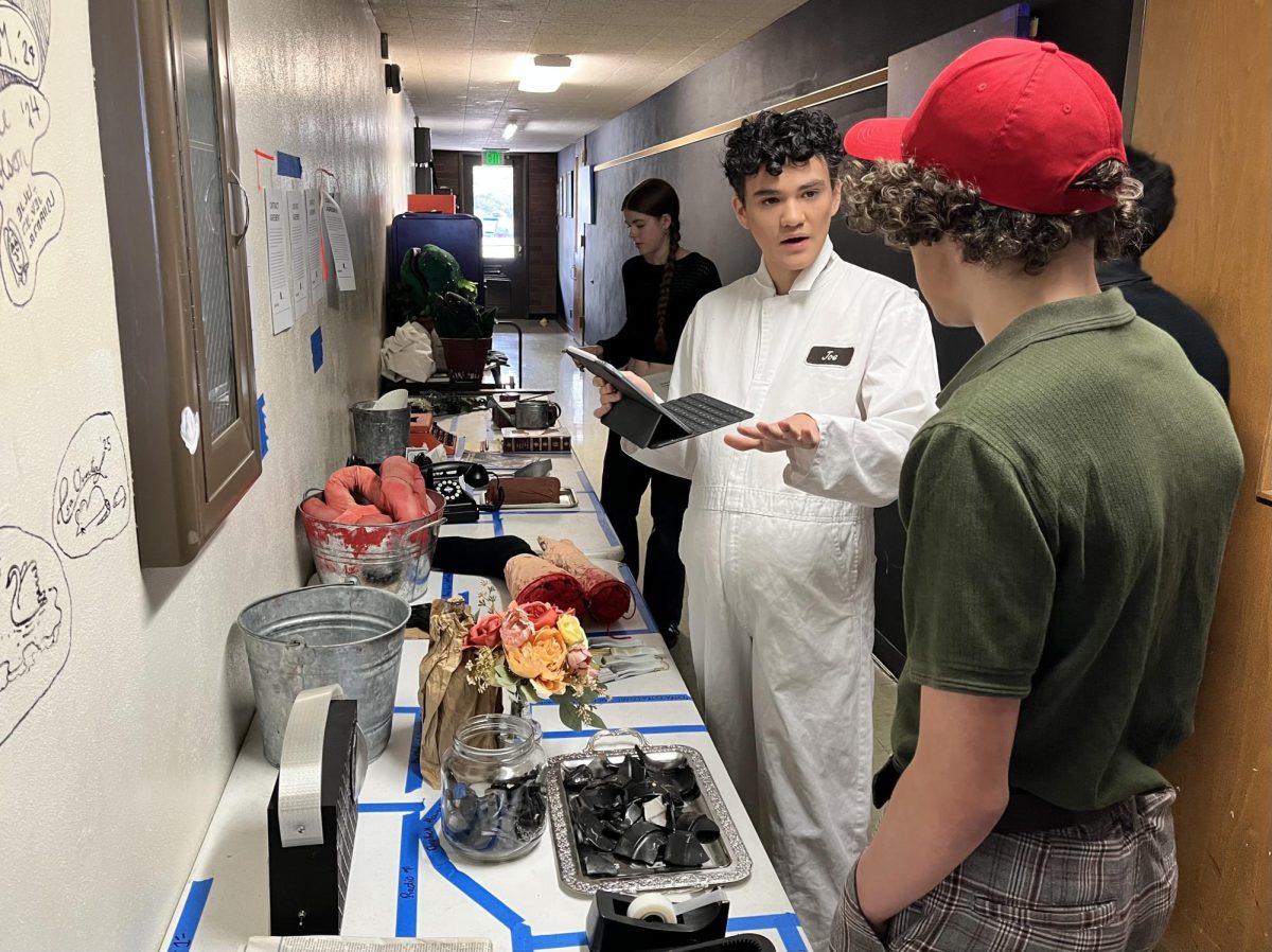 The actors who play Seymour go over the props needed for their role before the middle school matinee of “Little Shop of Horrors” on Thursday, April 16.