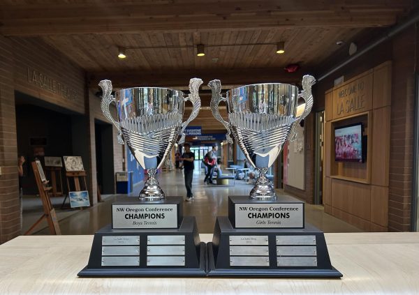 Boys and girls tennis conference trophies on display in main hall.